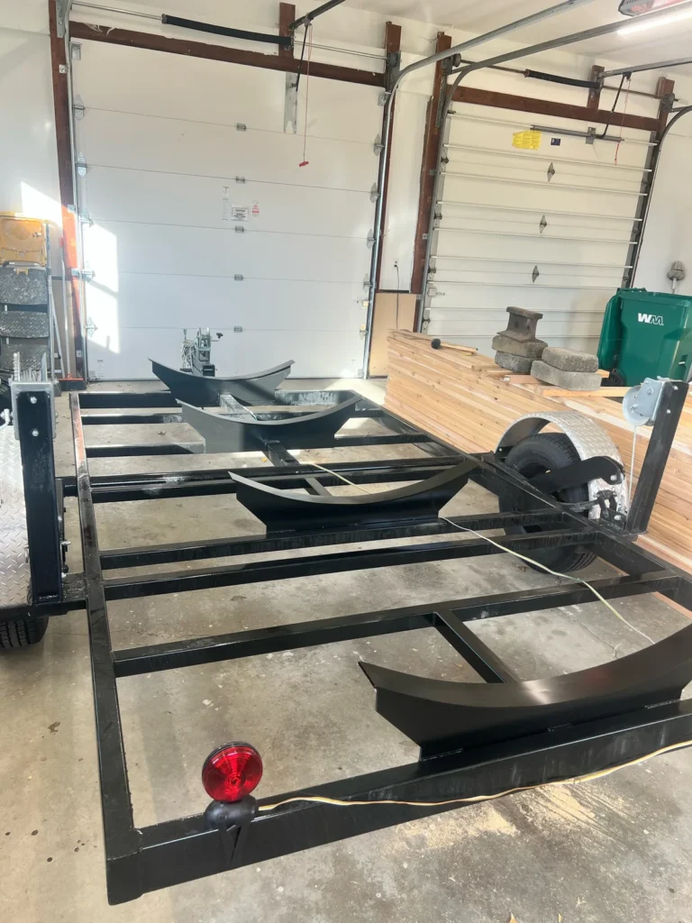Building a custom trailer sauna: curved cradles mounted on the trailer frame