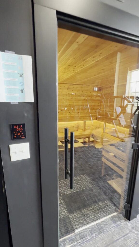 Glass door into the cedar sauna Sauna Craft built for Indy City Barbell in downtown Indianapolis
